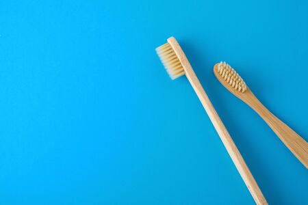 Bamboo toothbrush on blue background with spaceの写真素材