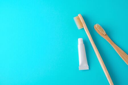 Toothbrushes with toothpaste, travel size, on blue background with spaceの写真素材