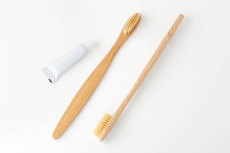 Bamboo toothbrushes and toothpaste, travel size, on white backgroundの写真素材