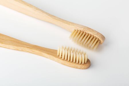 Bamboo toothbrushes, closeup on white backgroundの写真素材