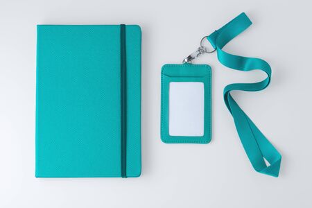 Leather notebook with badge and lanyard, pastel blue, corporate and event gift, mock up, top viewの写真素材