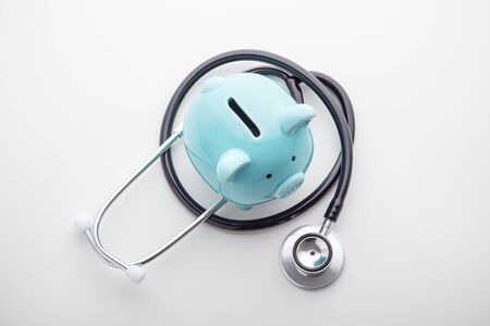 Piggy bank with stethoscope on white background, health saving account, hsa concept, top viewの写真素材