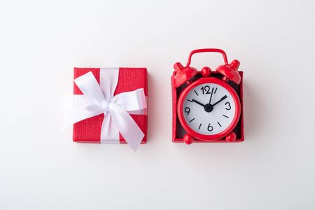 Clock in red gift box on white background, time conceptの写真素材