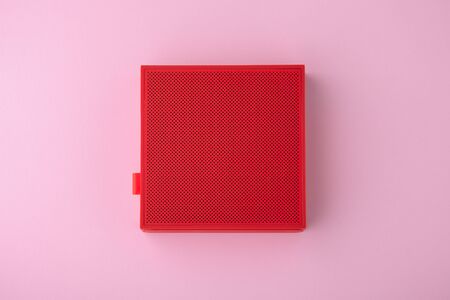 Red wireless speaker on pink background, minimalism, flat layの写真素材