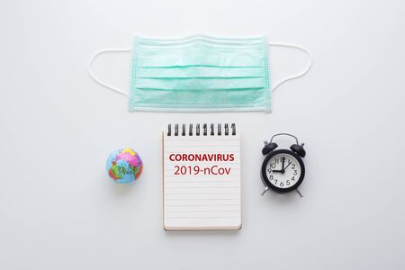 Coronavirus protection mask with clock and notebook, 2019-ncov global outbreakの写真素材