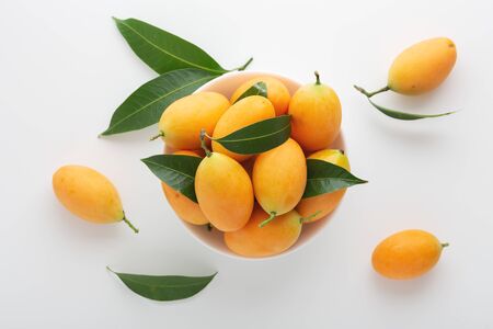 Marian plum or plum mango in white bowl, top viewの写真素材