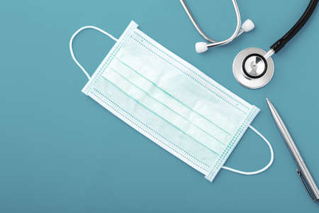 Health insurance claim form with stethoscope and surgical mask, top viewの写真素材