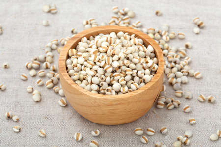 Pearl barley in wooden bowl on tableの写真素材