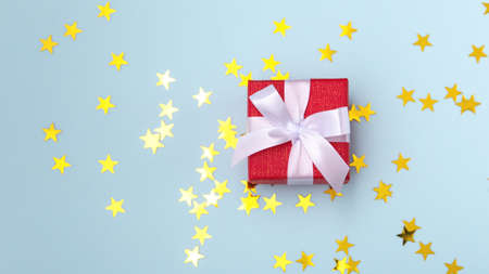Christmas gift box with glitter sparkle star on blue background, top viewの写真素材