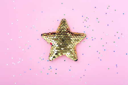 Shiny star with glitter on pastel pink backgroundの写真素材