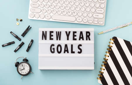 New year goals text on lightbox with office accessories on blue background, flatlayの写真素材