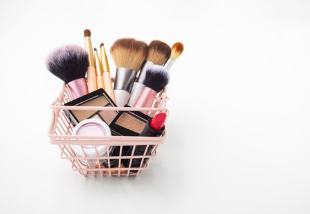 Makeup cosmetic products in shopping basket on white backgroundの写真素材