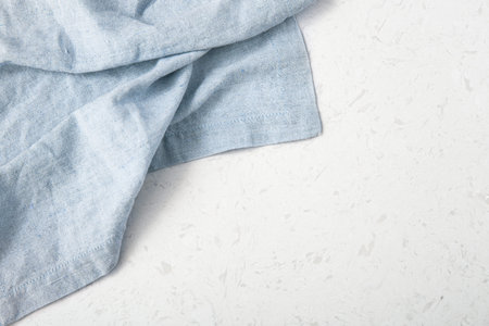 Blue linen tablecloth on marble kitchen table, top view