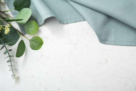 Tablecloth with green plant on marble table backgroundの写真素材
