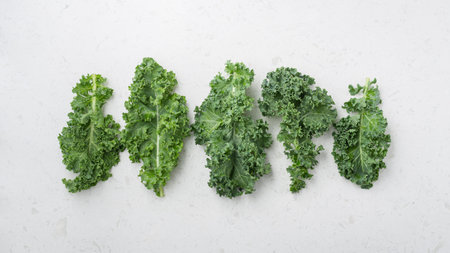 Kale leaves on marble table, top view
