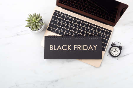 Black friday concept with laptop on marble table, online slaes, top view with copy spaceの写真素材
