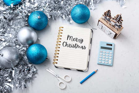 Merry christmas text on notebook with christmas decoration on marble tableの写真素材
