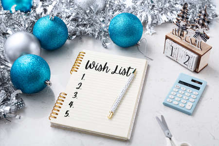 Christmas wish list on notebook with chirstmas decor on white marble tableの写真素材