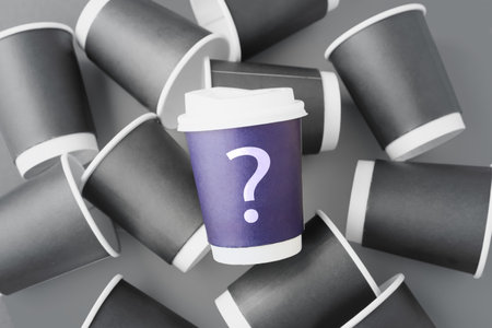 Brand identity and positioning concept, different and outstanding blue coffee cup with question mark among grey paper cupsの写真素材