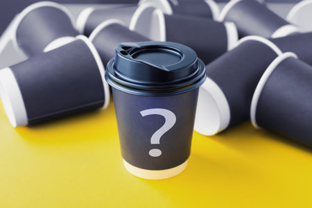 Coffee brand identity design concept, paper coffee cup with question mark on yellow table