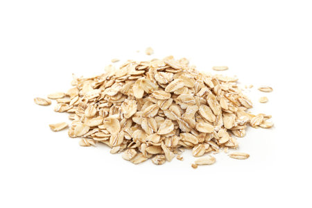 Pile of oat flakes isolated on white background, closeup