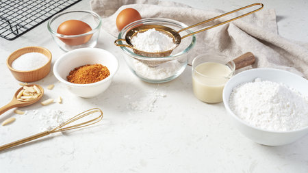 Baking background, pastry or cake ingredients, sifting flour, brown sugar, eggs and milk with...