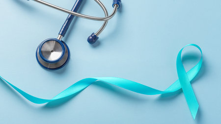 Blue awareness ribbon with stethoscope on blue background, top viewの写真素材