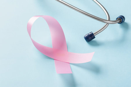 Breast cancer awareness pink ribbon with stethoscope on blue backgroundの写真素材