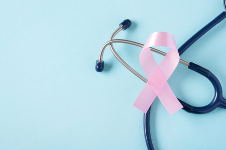 Pink ribbon with stethoscope on blue background with copy space, breast cancer awareness monthの写真素材