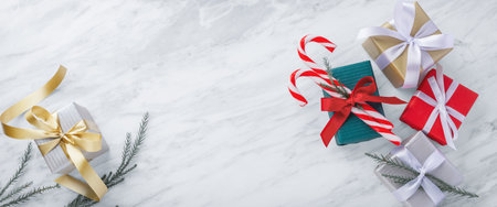Christmas gift background, gift boxes with ribbon bow on marble table, top view, copy spaceの写真素材