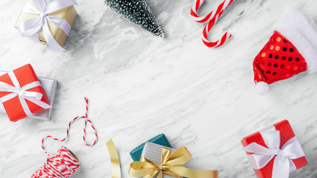 Christmas background with gift box and christmas decoration on marble table, top view