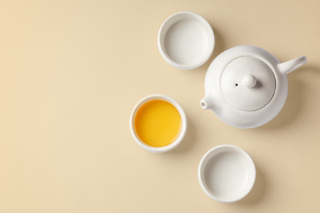 Tea cup set with teapot on beige background, top view with copy spaceの写真素材