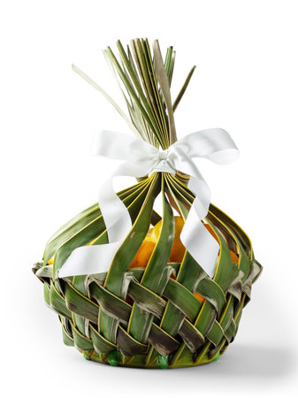 Oranges fruit in natural basket with bow ribbon isolated on white backgroundの写真素材