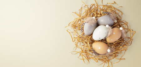 Easter holiday background, easter eggs with feathers decor on gold glitter shredded paper, top view, copy spaceの写真素材