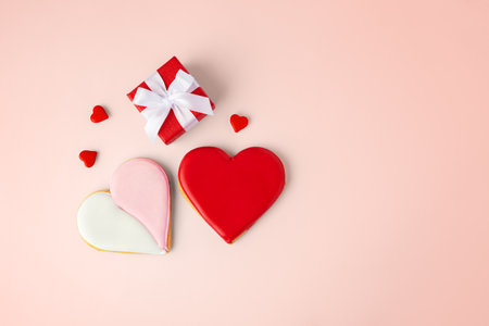 Valentines day background, love heart cookies and gift box, top viewの写真素材