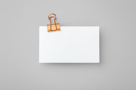 Copper binder clip with memo note paper on grey backgroundの写真素材
