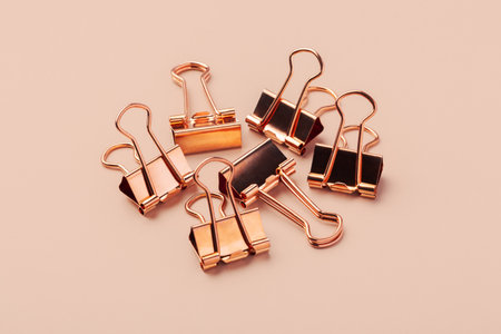 Heap of copper gold binder paper clips mockupの写真素材