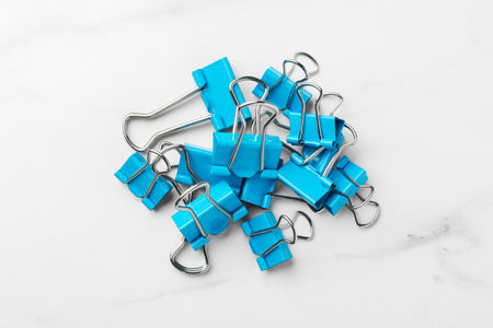 Blue binder paper clips on marble table background, top viewの写真素材