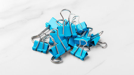 Paper binder clips on marble table backgroundの写真素材