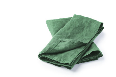 Green natural linen napkin cloth folded isolated on white background, copy spaceの写真素材