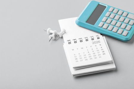 2026 Calendar with blue calculator and pins, tax payment, financial planning, copy spaceの写真素材