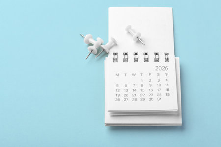 Calendar 2026 with white pins on light blue background, business schedule, planner, reminder concept, copy spaceの写真素材