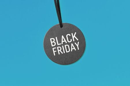 Black friday word on sale tag on blue background