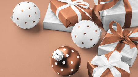 Christmas holiday mocha mousse color background, Gift boxes, present with brown bow ribbon and...