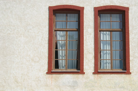 Two windows on a white wall
