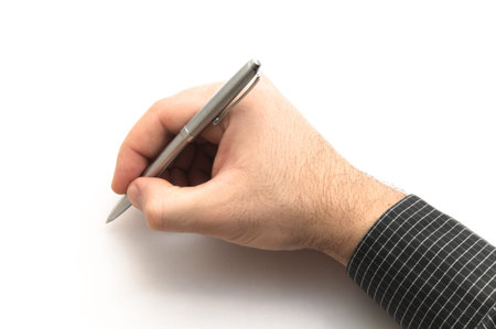 Hand with black shirt holding silver metal pen on white background, writingの写真素材