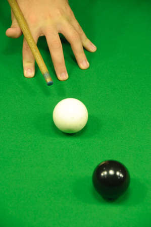 Player striking the white ball (aiming at the black) (view from above)の写真素材