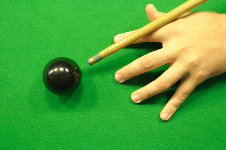 Professional hand and cue position when striking the black ball (view from above)