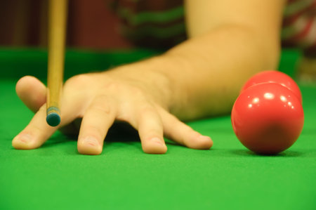 Professional hand position when holding the cue (in this case, a snooker cue) (next to a couple of...