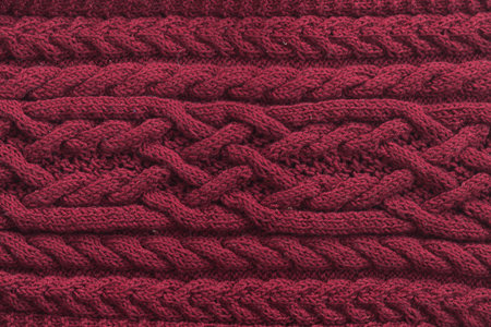 Knitted pattern from natural wool. Texture, close-up red